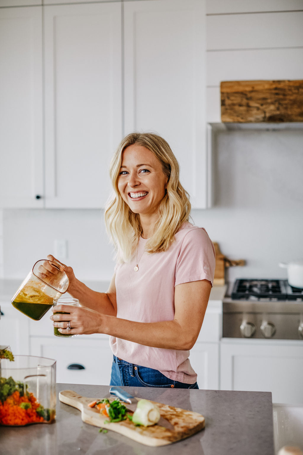 Woman making green juice to rebuild and support her HCL levels