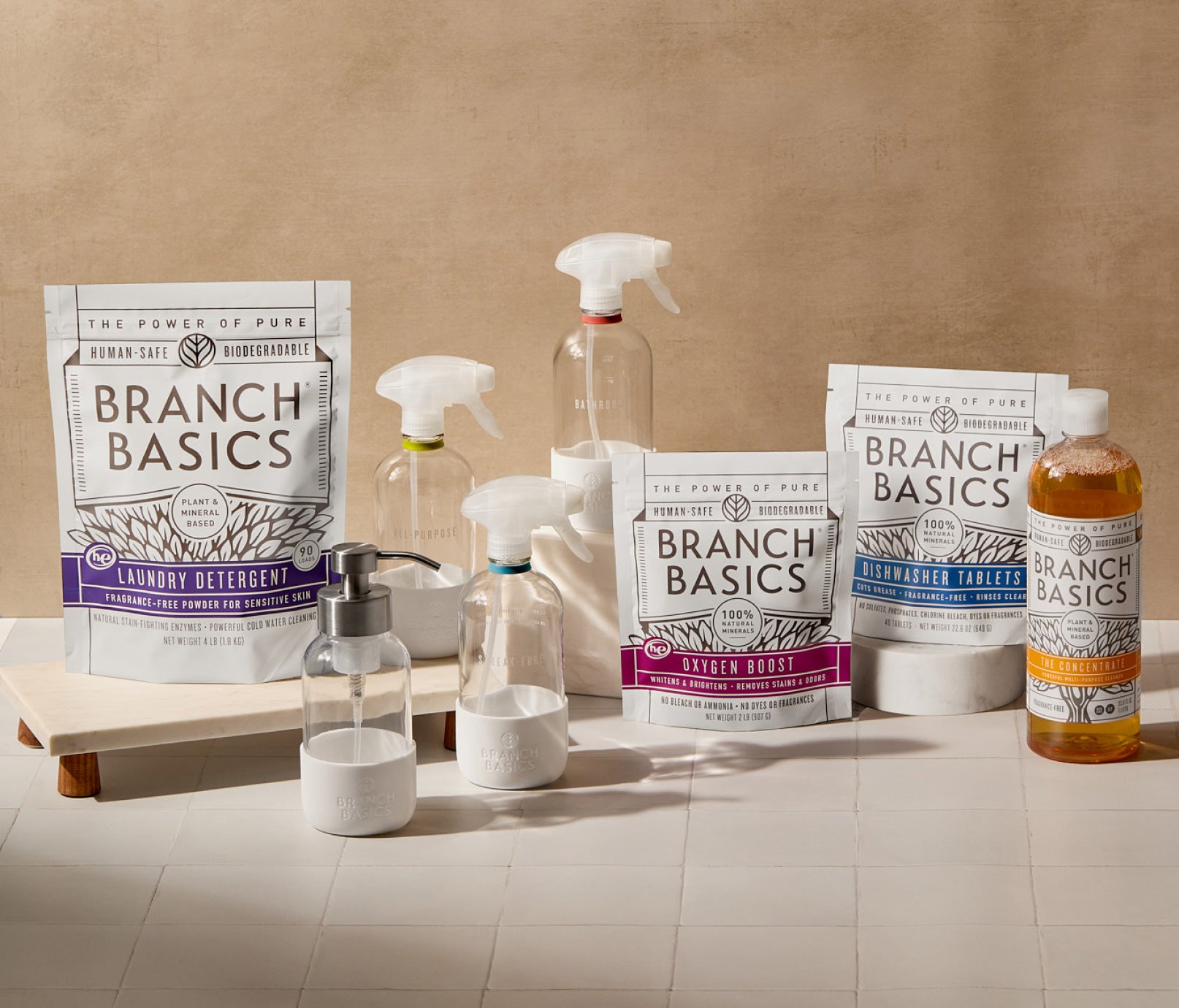 The Ultimate Starter Kit featuring refillable Glass bottles, displayed against a neutral tile background. - View 1
