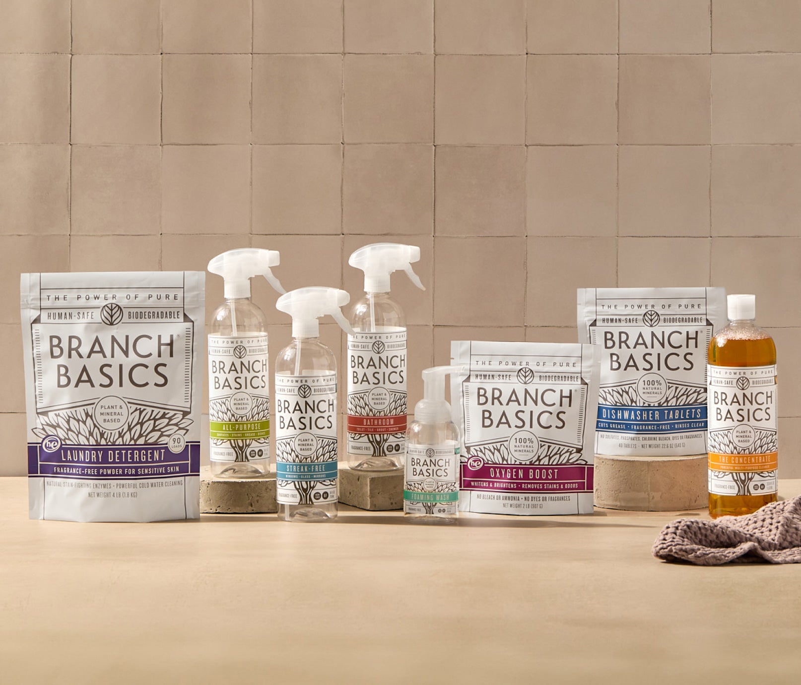 The Ultimate Starter Kit featuring refillable Plastic bottles, displayed against a neutral tile background. - View 1
