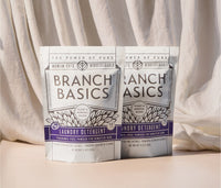 Two pouches of Branch Basics Laundry Detergent displayed on a beige surface with a neutral background. - Thumbnail View 1
