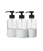 A trio of refillable Glass Foaming Wash Bottles with Matte-Black pumps, displayed on a transparent background.