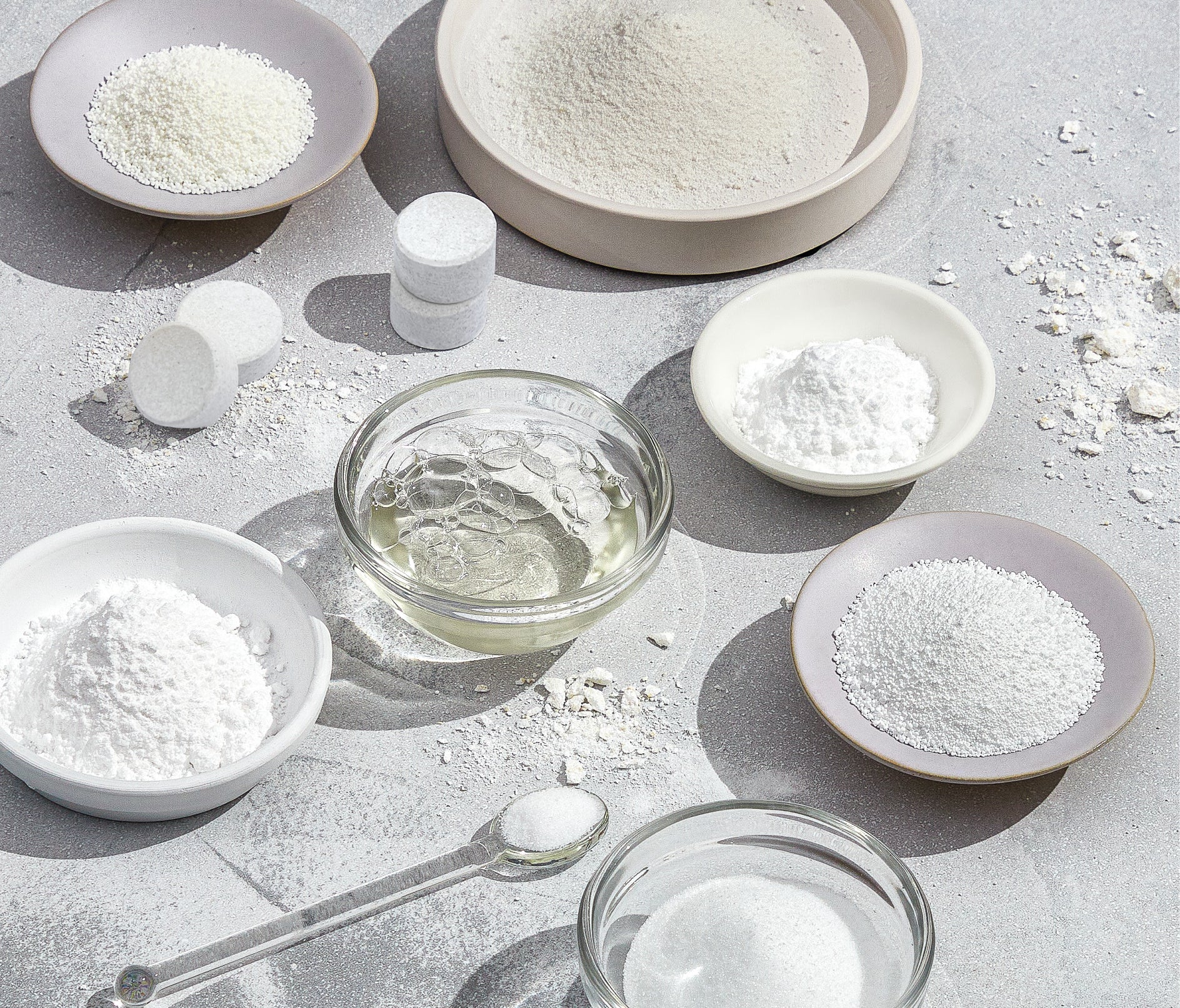 An array of glass and ceramic bowls, each containing an ingredient included in Branch Basics Dishwasher Tablets. - View 5

