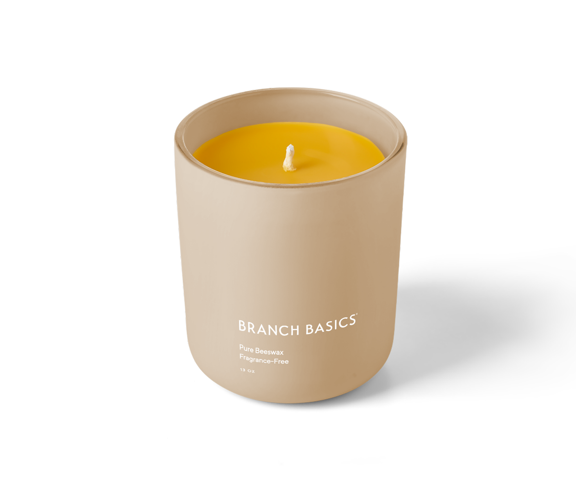 A Branch Basics 100% Beeswax Candle, housed in a glass jar with an organic cotton wick, displayed on a transparent background. - View 1
