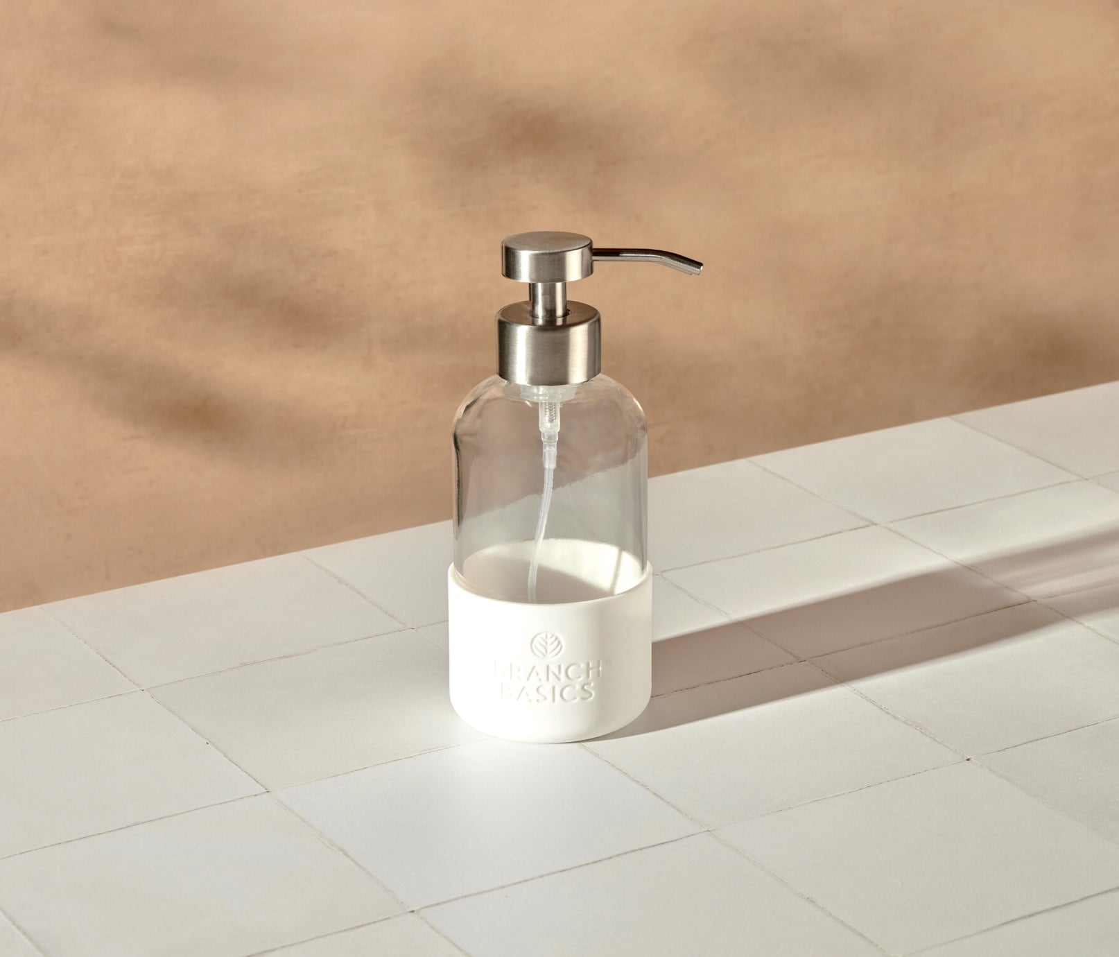 A single refillable Glass Foaming Wash Bottle with a Brushed-Chrome pump, displayed on a white surface and neutral background. - View 2
