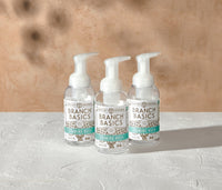 A trio of refillable Plastic Foaming Wash Bottles, displayed on a white surface and neutral background. - Thumbnail View 2
