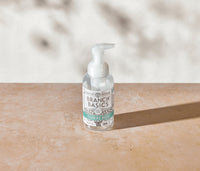 A single refillable Plastic Foaming Wash Bottle, displayed on a neutral surface and white background. - Thumbnail View 2

