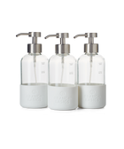 A trio of refillable Glass Foaming Wash Bottles with Brushed-Chrome pumps, displayed on a transparent background.