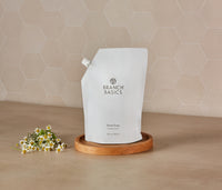 A pouch of Branch Basics Gel Hand soap, displayed on a wooden tray against a neutral tiled background. - Thumbnail View 3
