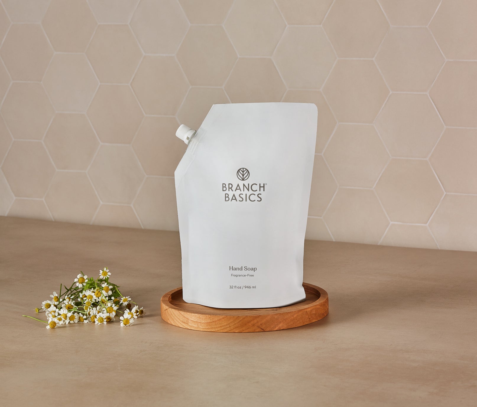 A pouch of Branch Basics Gel Hand soap, displayed on a wooden tray against a neutral tiled background. - View 3
