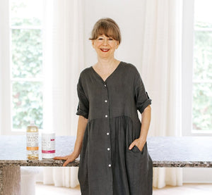 Marilee Nelson standing with Branch Basics bottles