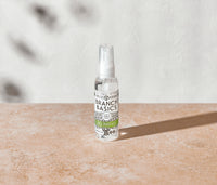 A mini-bottle of the Branch Basics All-Purpose spray, displayed on a neutral surface and white background. - Thumbnail View 2
