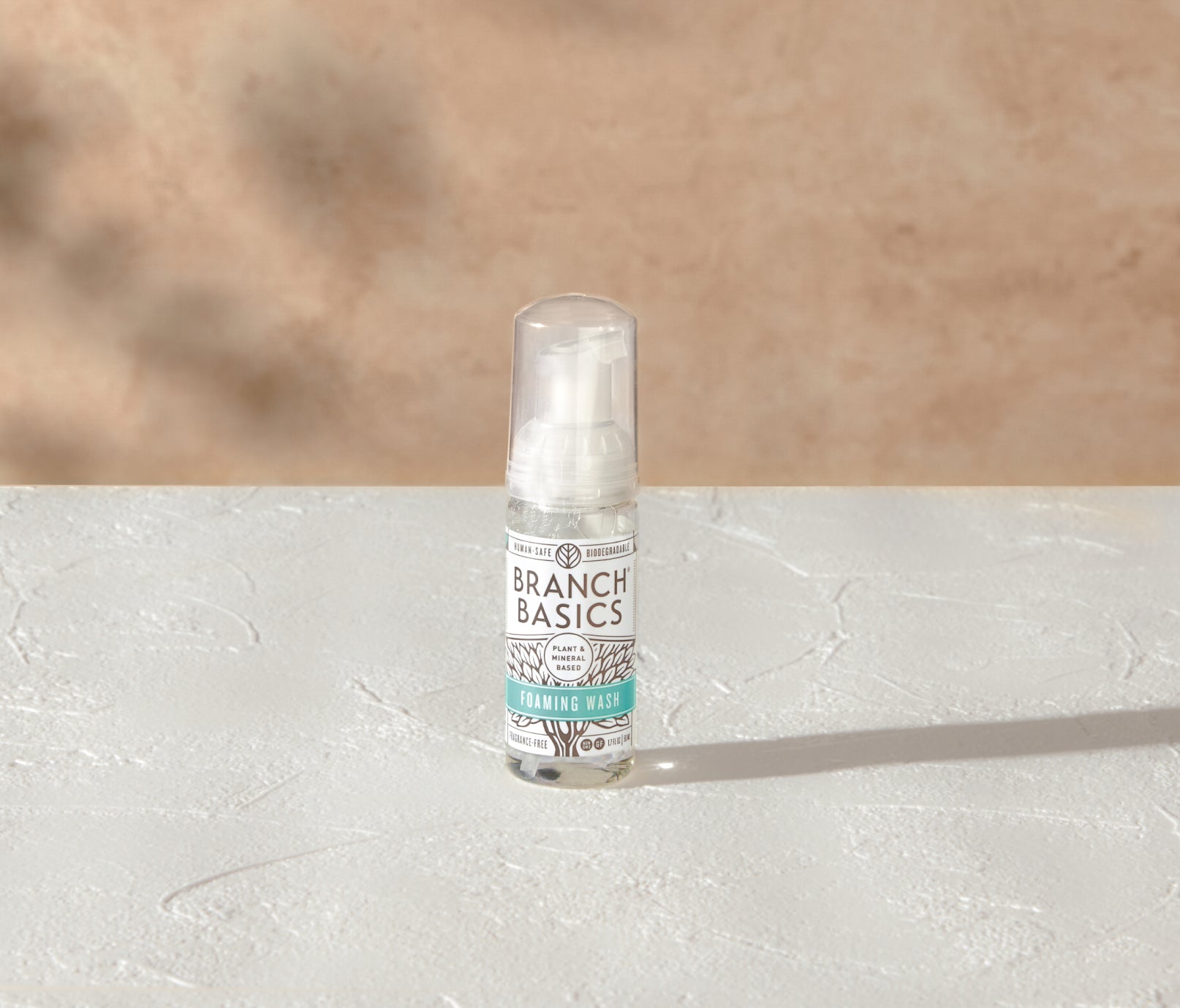 A mini-bottle of the Branch Basics Foaming Wash dispenser, displayed on a white surface and neutral background. - View 2
