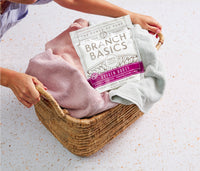 A full laundry basket with a pouch of Branch Basics Oxygen Boost sitting on top. - Thumbnail View 5

