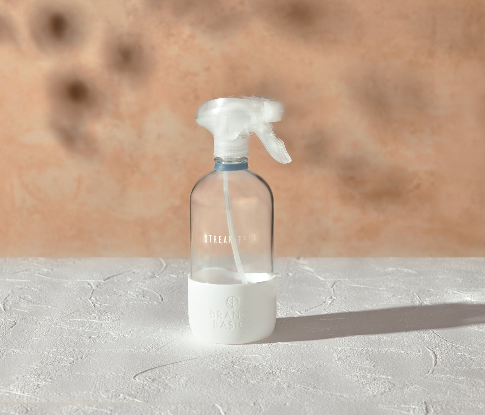 A refillable Glass Streak-Free bottle, used to dilute and dispense Branch Basics Concentrate with water, displayed on a white surface and neutral background. - View 2
