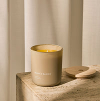 A Branch Basics 100% Beeswax Candle, housed in a glass jar with an organic cotton wick, displayed on a neutral background. - Thumbnail View 2
