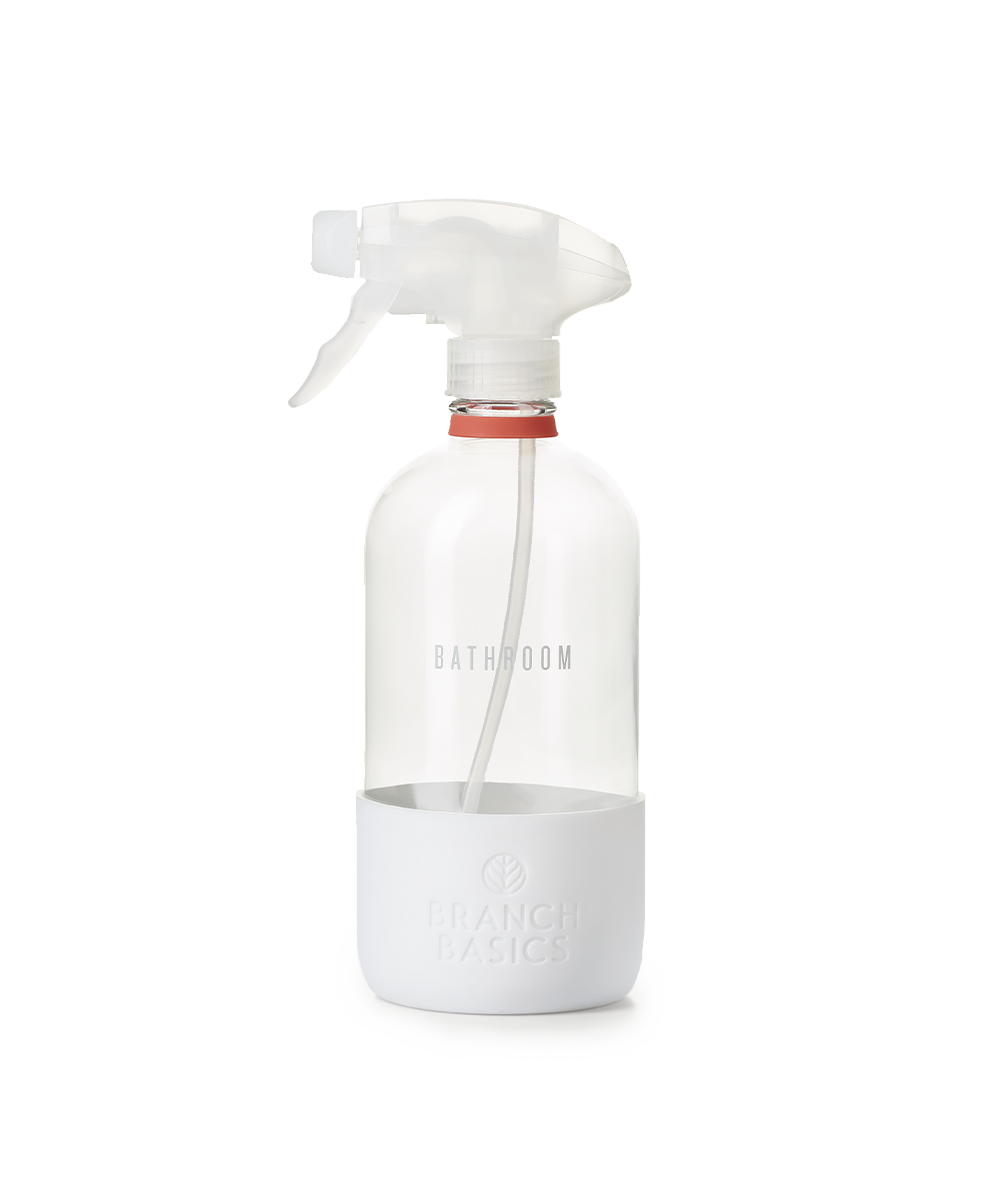 A refillable Glass Bathroom bottle, used to dilute and dispense Branch Basics Concentrate with water, displayed on a transparent background. - View 1
