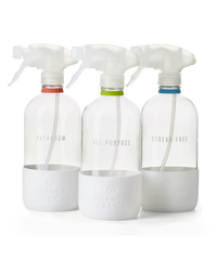 The Glass Bottles Essentials Pack, featuring Bathroom, All-Purpose, and Streak-Free versions of Branch Basics refillable Glass bottles, displayed on a transparent background. - Thumbnail View 1
