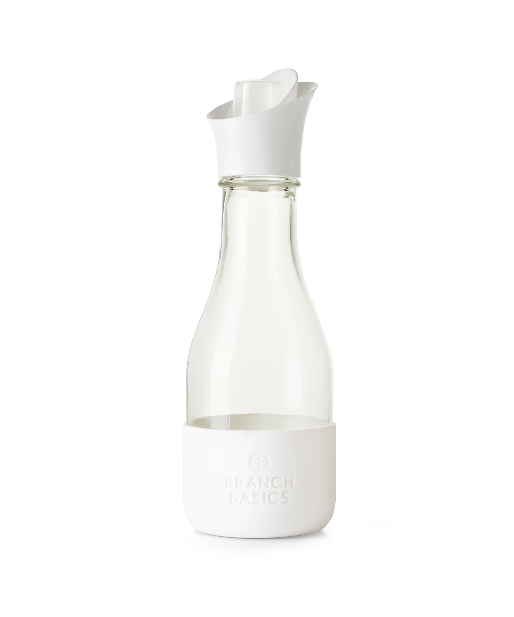A refillable Glass Laundry bottle, used to dilute and dispense Branch Basics Concentrate with water, displayed on a transparent background. - View 1
